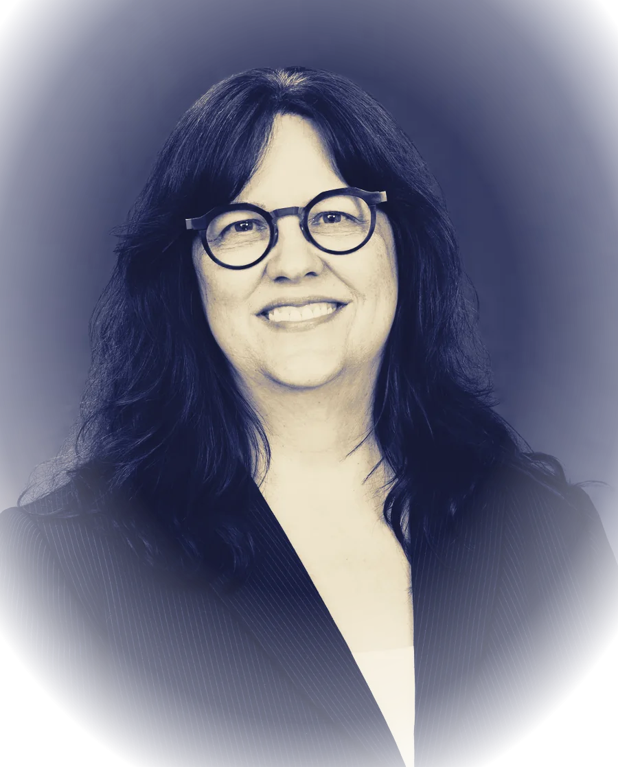 Nadia Botelho: a woman in her forties with dark wavy hair and round glasses, printed as a two-ink almanac plate in indigo and brass.